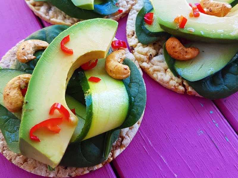 CORN THINS slices with avocado, cashews, spinach leaves, zucchini & chilli