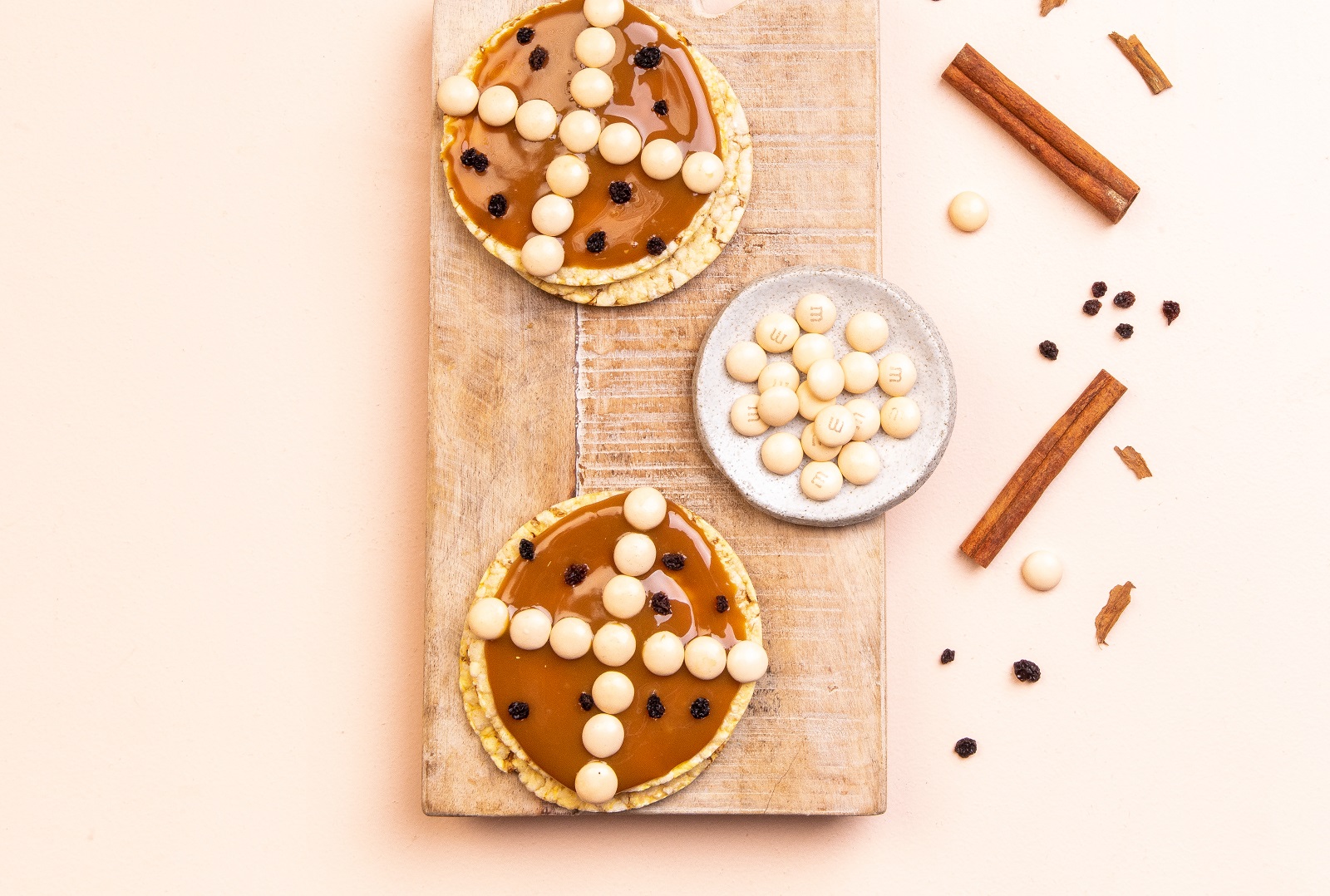 Hot Cross Bun version of Corn Thins. Caramel spread, white M&Ms + currants on Corn Thins slices