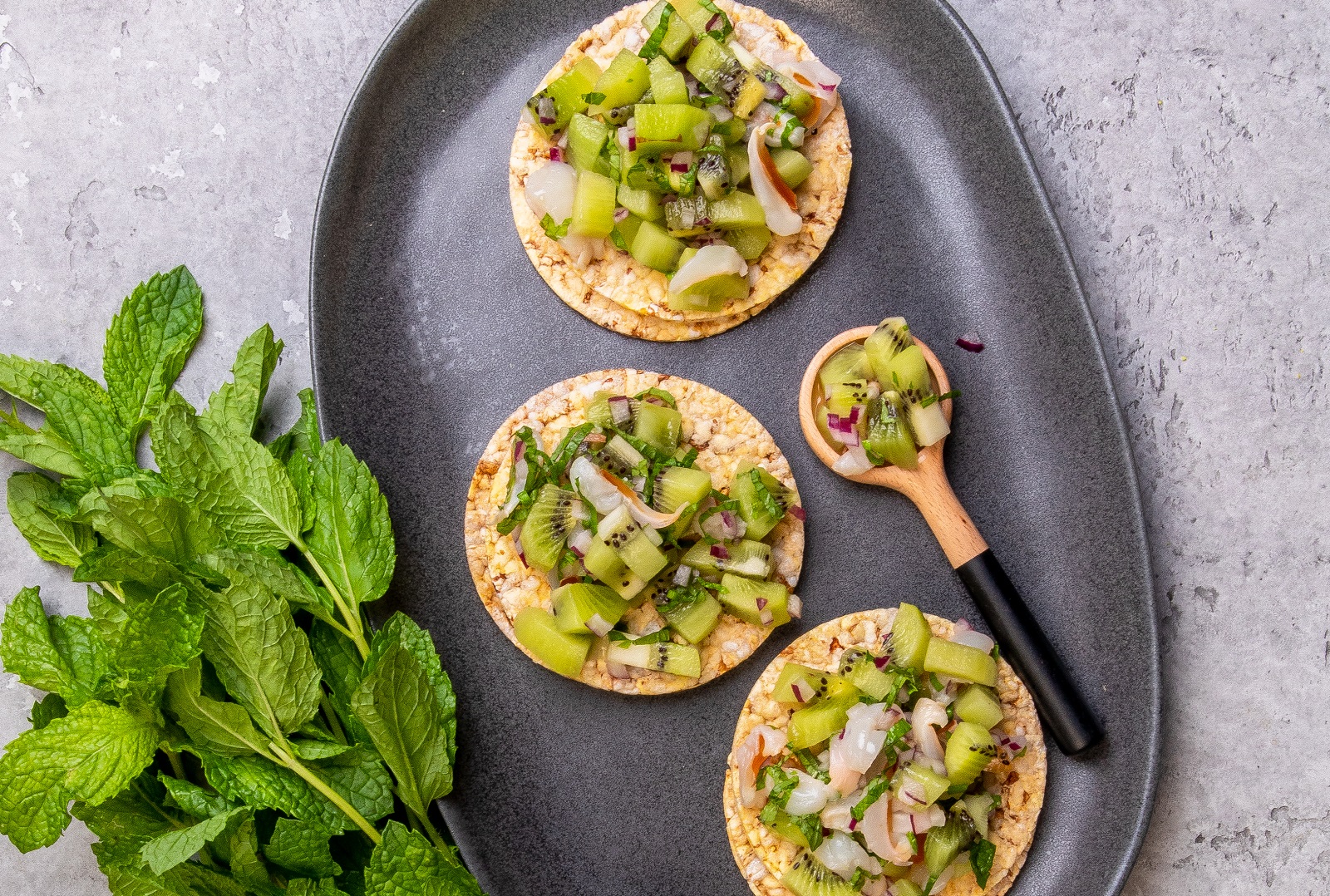 Kiwi Fruit, Lychee, Red Onion & Mint on CORN THINS slices