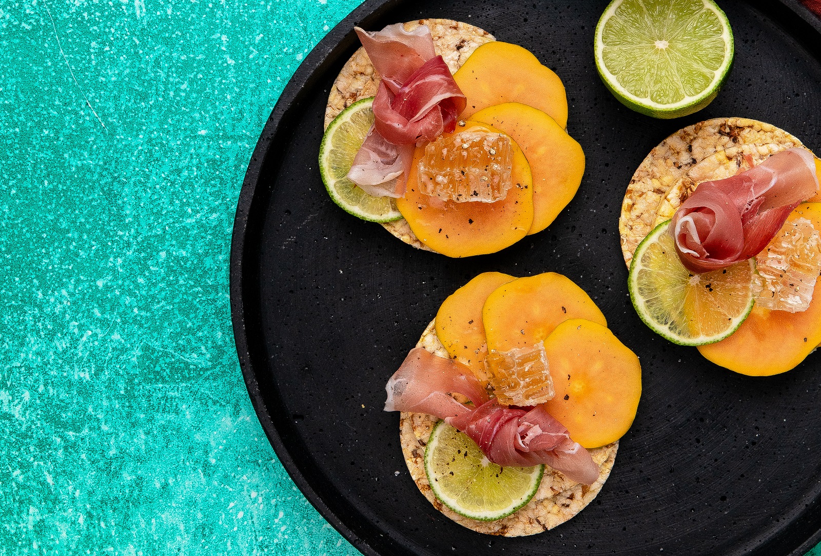 Papaya, Prosciutto, Honey & Lime on Corn Thins slices