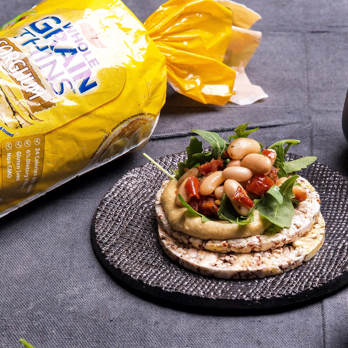 Hommus, rocket, white beans & sundried tomato on Corn Thins slices for lunch