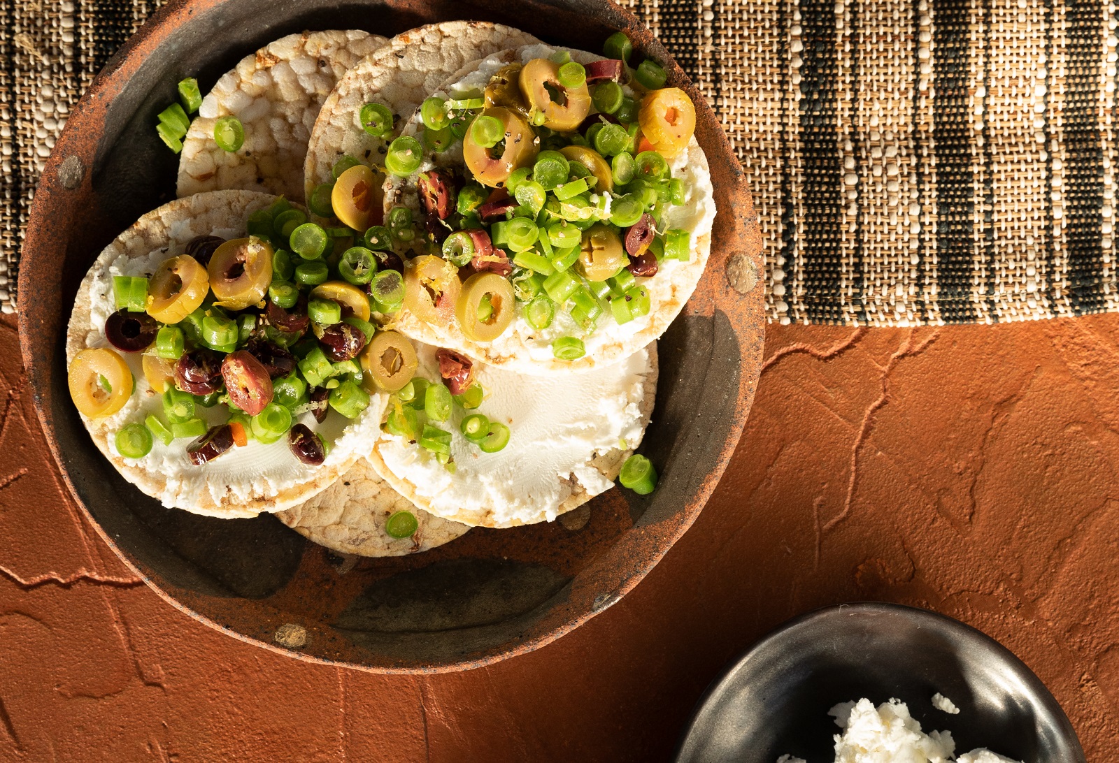 Goats Cheese, Fresh Beans, Mixed olives, lemon zest & pepper on Corn Thins slices