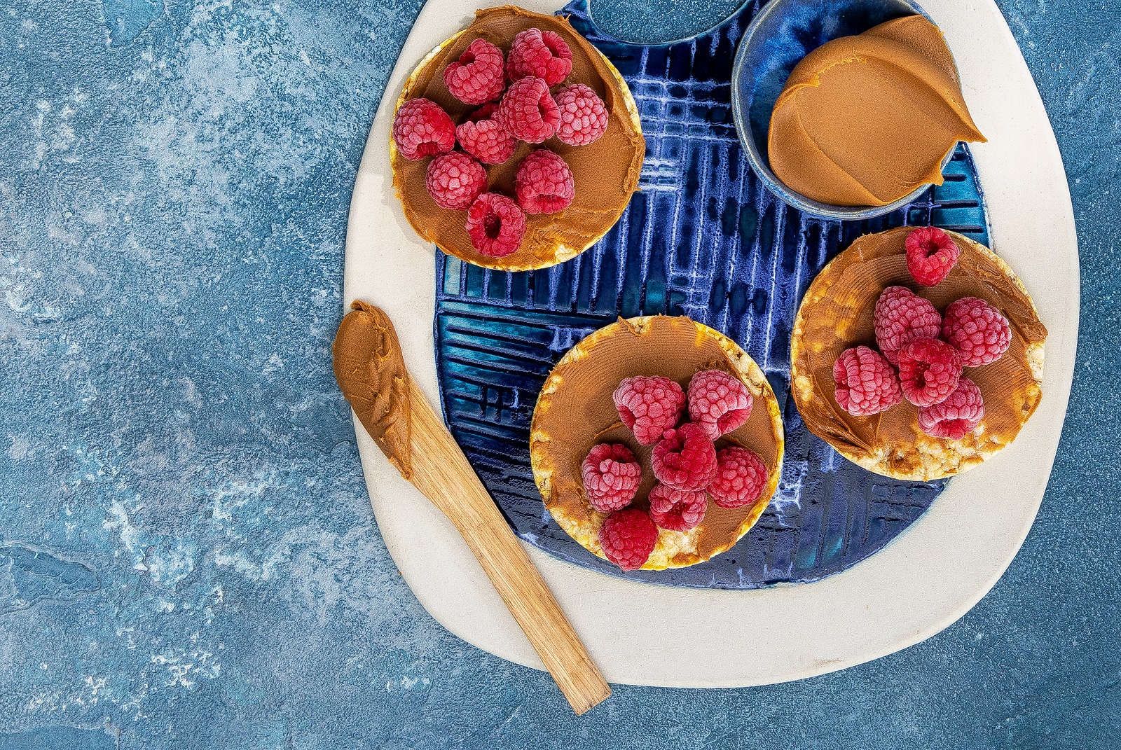 Lotus Biscoff Spread & Frozen Raspberries on Corn Thins slices
