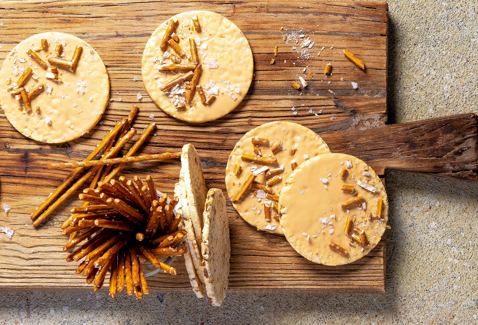 Corn Thins sliced dipped in melted caramilk & sprinkled with crushed pretzels