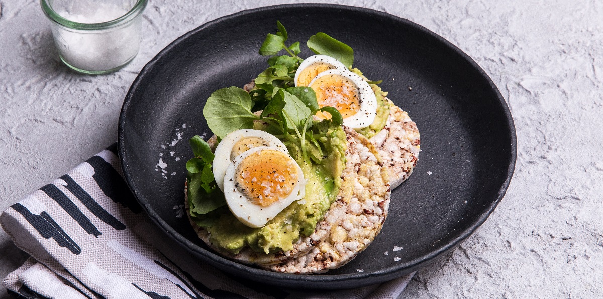 Boiled egg, avocado, watercress on Corn Thins slices