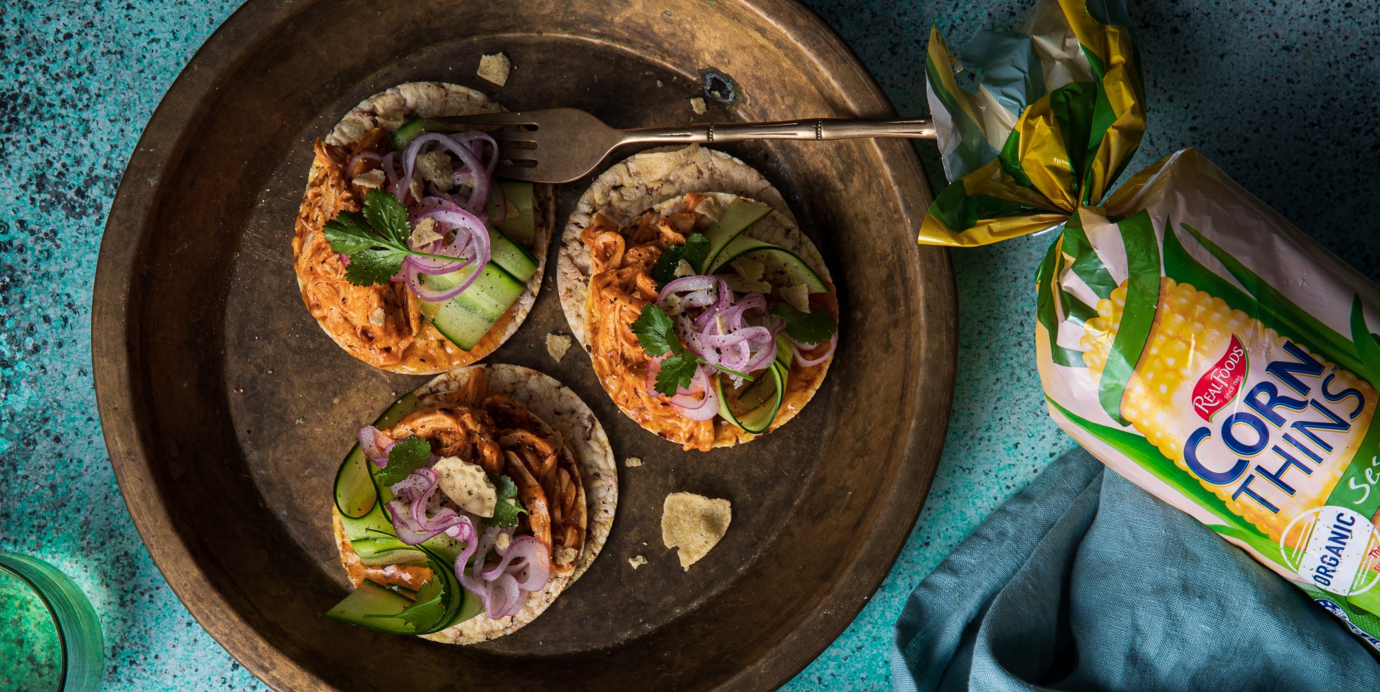 Coronation chicken, cucumber, pickled red onions, & coriander on Corn Thins slices