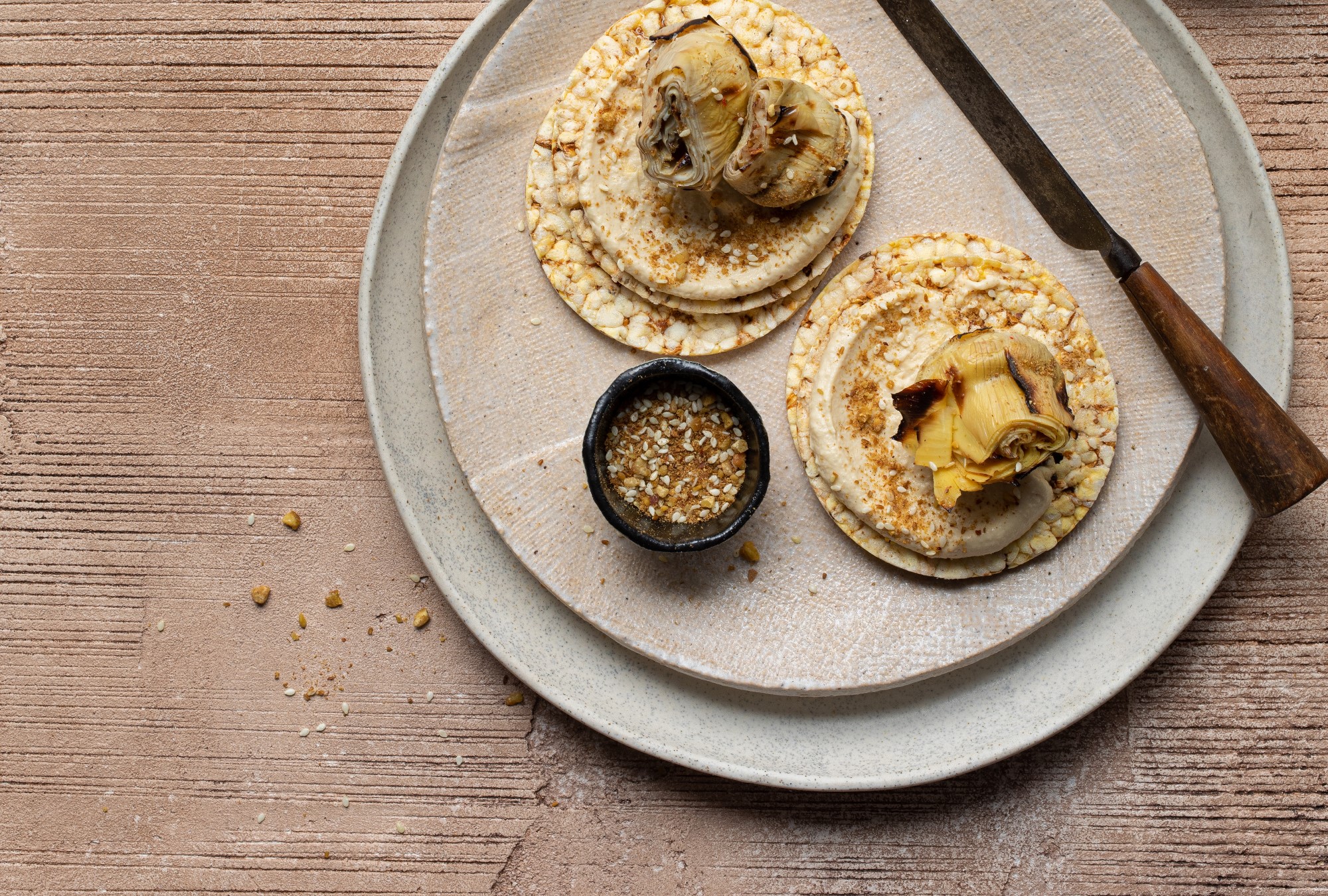 Hommus, Marinated Artichoke & Dukkah on Corn Thin slices