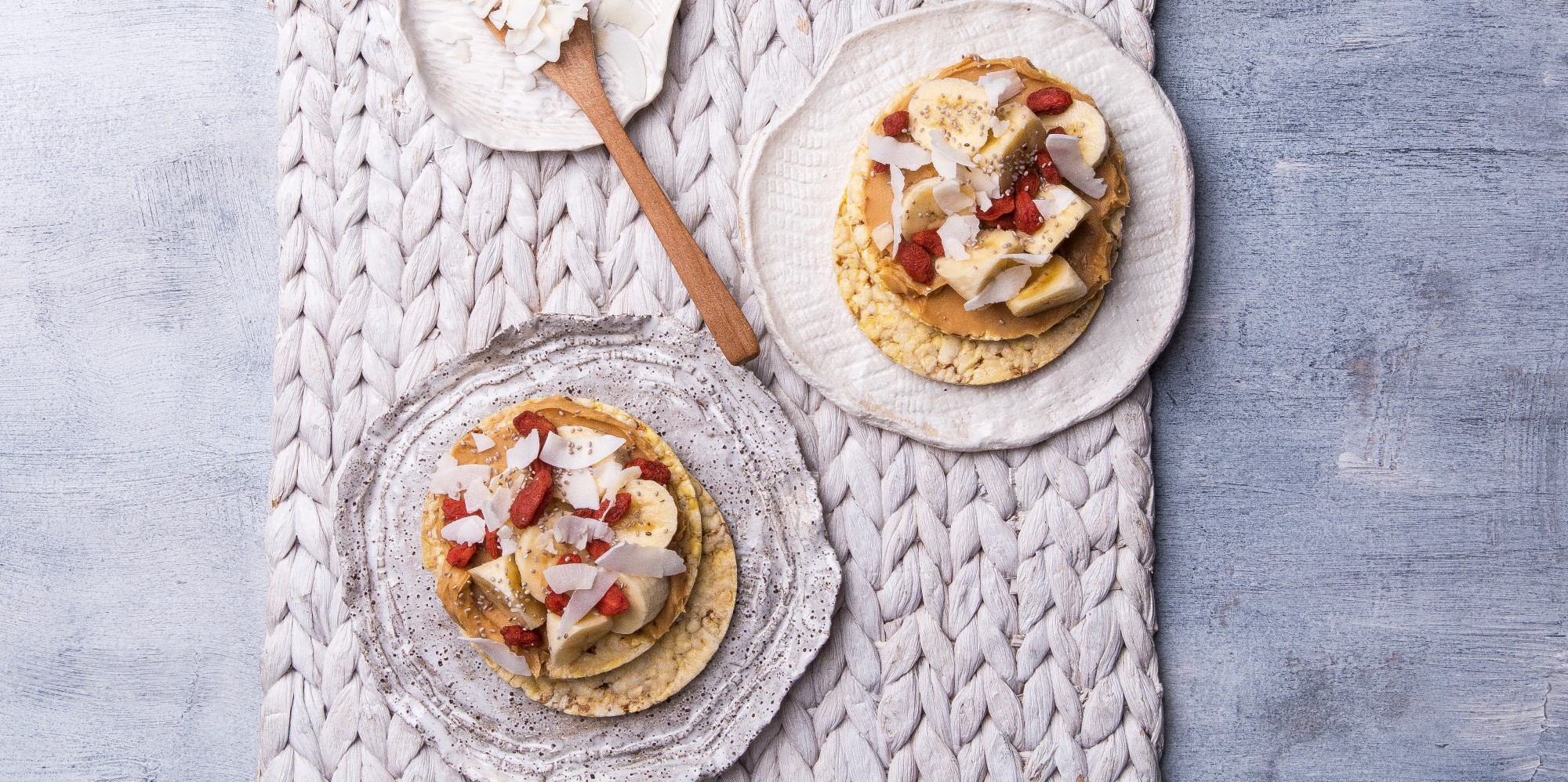 Peanut butter, banana, goji berries, coconut flakes & chia seeds on Corn Thins slices