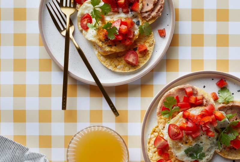 Refried Beans, Tomato & Capsicum Salsa, Fried Egg & Coriander on Corn Thins slices