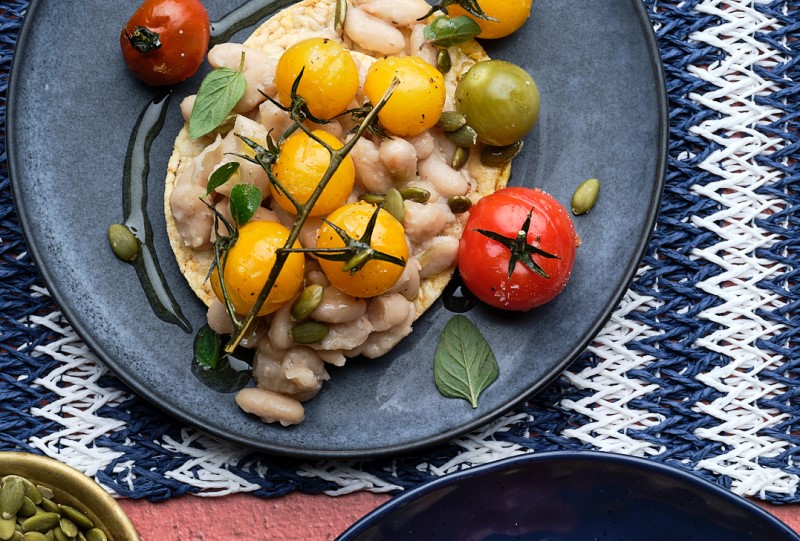 Smashed white bean, roast cherry tomato, pepita & Oregano on Corn Thins slices