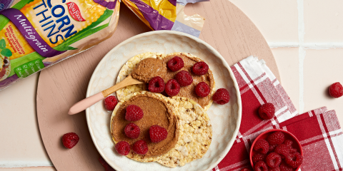 Almond butter mixed with choc protein powder & raspberries on Corn Thins slices