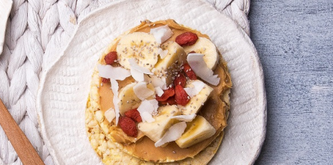 Peanut butter, banana, goji berries, coconut flakes & chia on Corn Thins slices