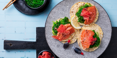 Seaweed salad, salmon, pickled ginger & sesame seeds on Corn Thins slices