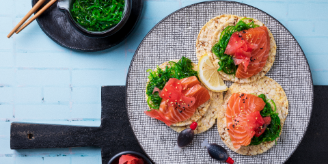 Seaweed salad, Salmon sashimi, pickled ginger & sesame seeds on Corn Thins slices