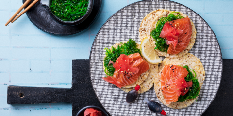 Seaweed salad, salmon, pickled ginger & sesame seeds on Corn Thins slices