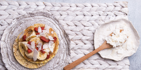 Peanut butter, banana, goji berries, coconut flakes & chia on Corn Thins slices