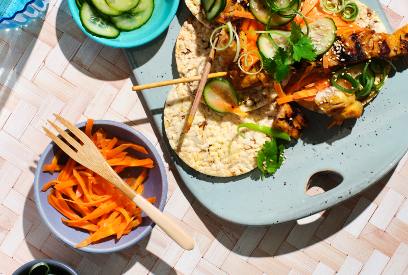 satay chicken, pickled carrot and cucumber, coriander, spring onion and sesame seeds on Corn Thins slices