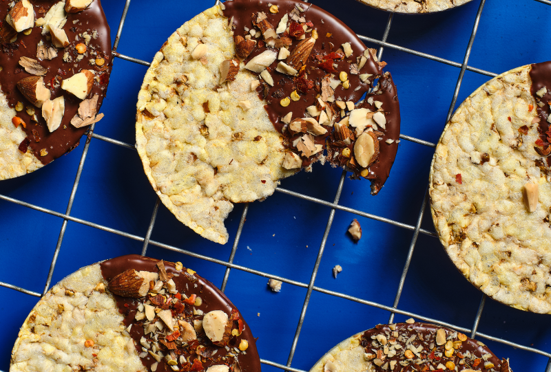 Corn Thins slices dipped in dark chocolate with roasted almonds & chilli flakes