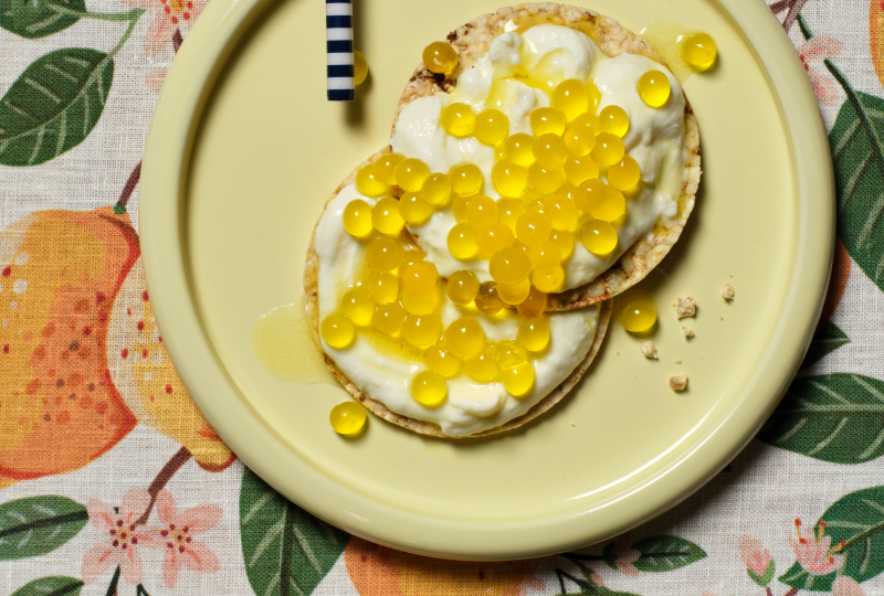 Coconut Yoghurt and Passionfruit Pearls on Corn Thins slices