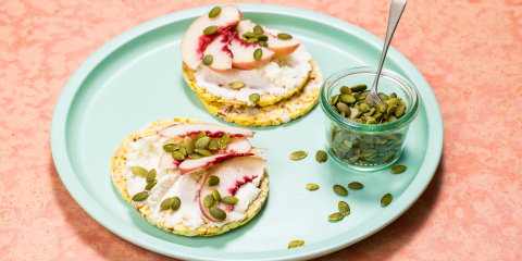Ricotta, white peach & pepitas on Corn Thins slices