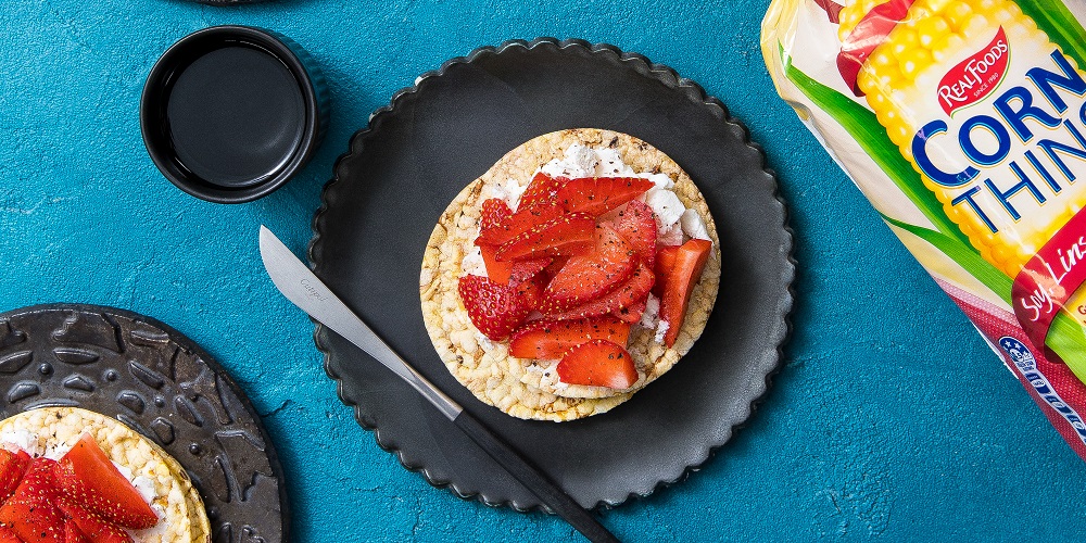 Goat cheese, strawberries, black pepper on Corn Thins slices