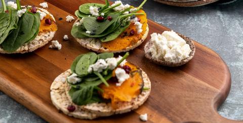 Roast pumpkin, baby spinach, goat's cheese, pomegranate on corn thins slices