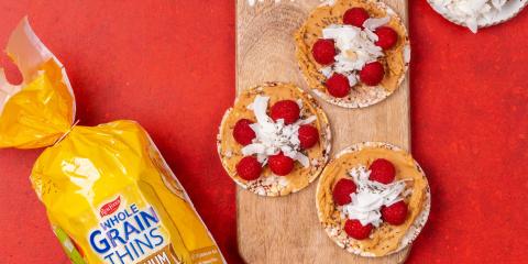 Peanut butter, raspberry, coconut flakes & chia on Corn Thins slices