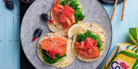 Seaweed salad, Salmon sashimi, pickled ginger & sesame seeds on Corn Thins slices