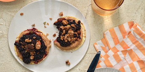 Almond butter, smashed blackberries & Granola on Corn Thins slices