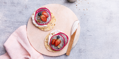 Coconut yoghurt, dragonfruit, strawberry, and blueberries on Corn Thins slices