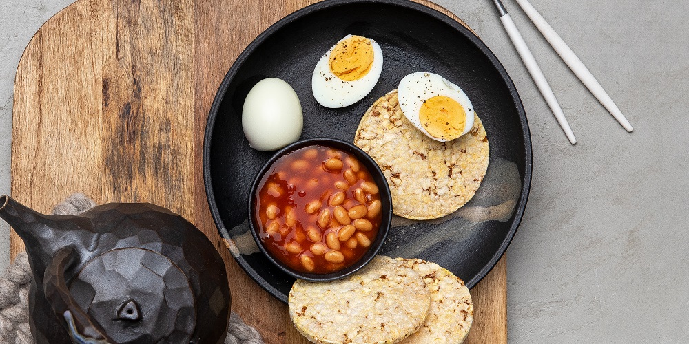 Beans & eggs with Corn thins slices for breakfast