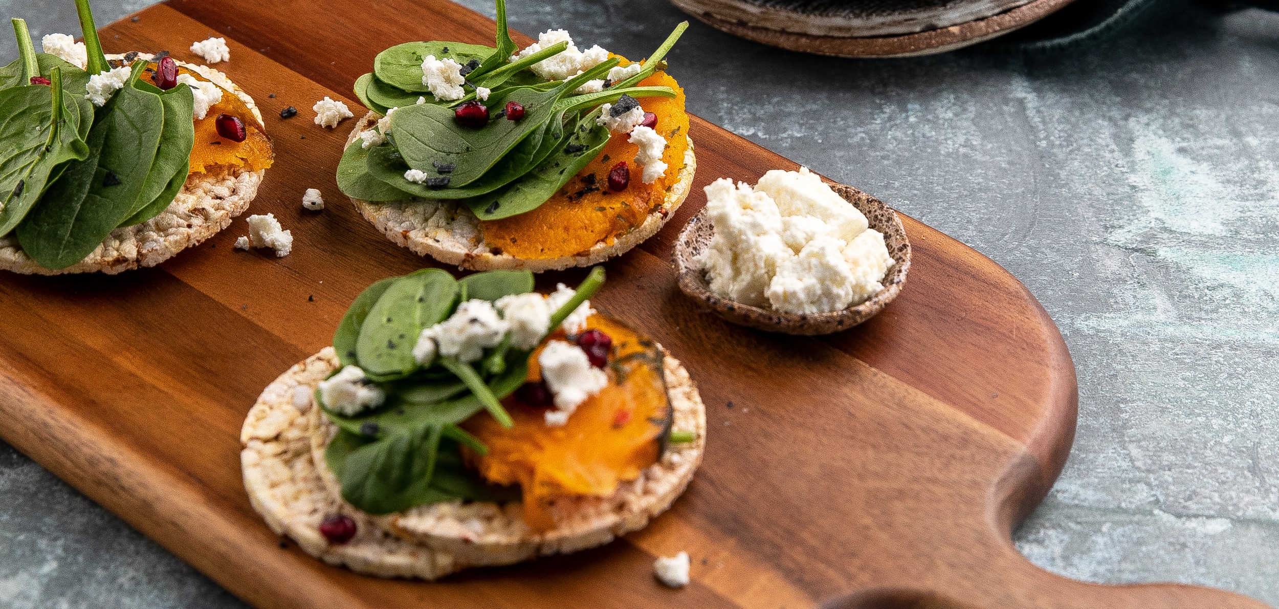 Roast Pumpkin, Baby Spinach, Goat Cheese & Pomegranate on Corn Thins slices