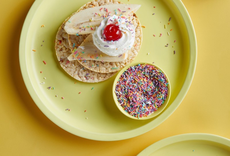 Banana, Whipped Cream, Sprinkle & Cherry on Corn Thins slices